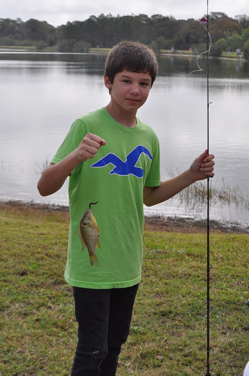 Eleven-year-old Connor Kirk catches a 7-inch sunfish.