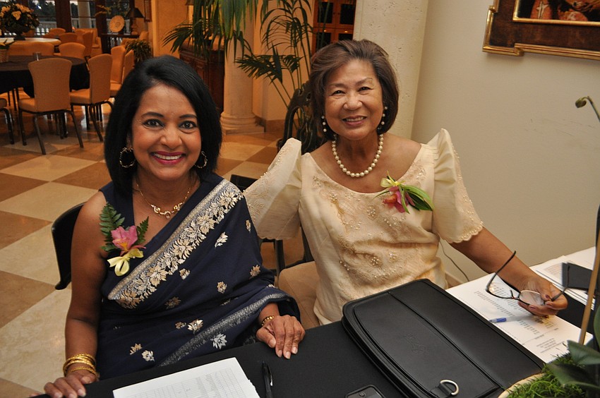 Treasurer Sandy Wick and secretary Mercedes Rivera register guests.