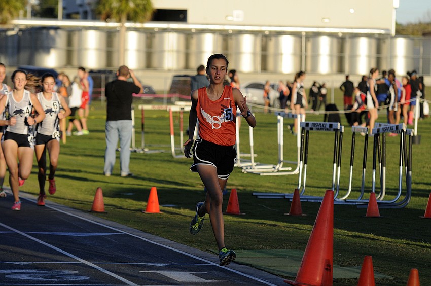 Sarasotaâ€™s Angelina Grebe breaks away from the pack during the 1600-meter run.
