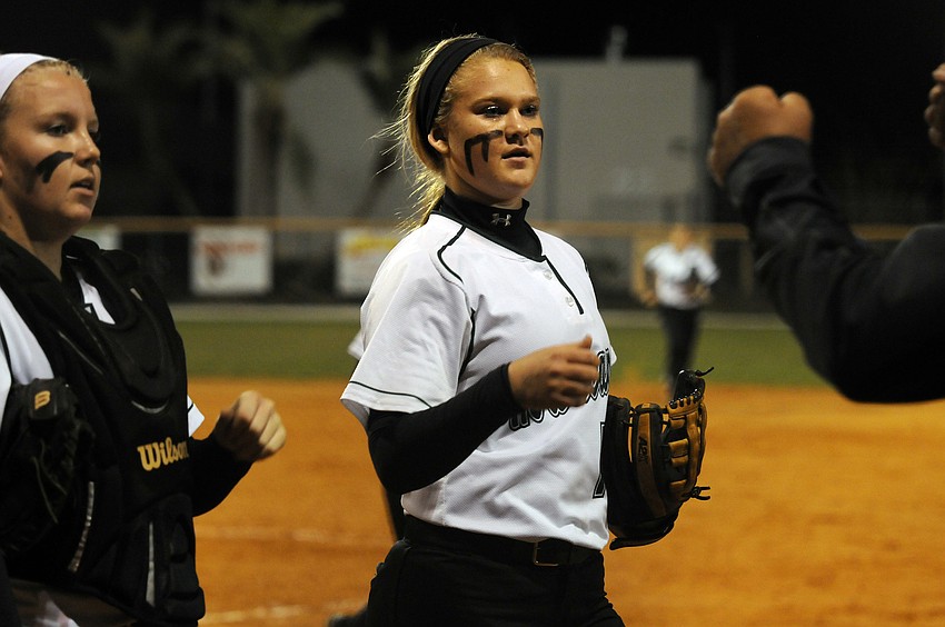 Lakewood Ranch catcher Talli Sharp and pitcher Amanda Rak are congratulated by their coach following a scoreless first inning.