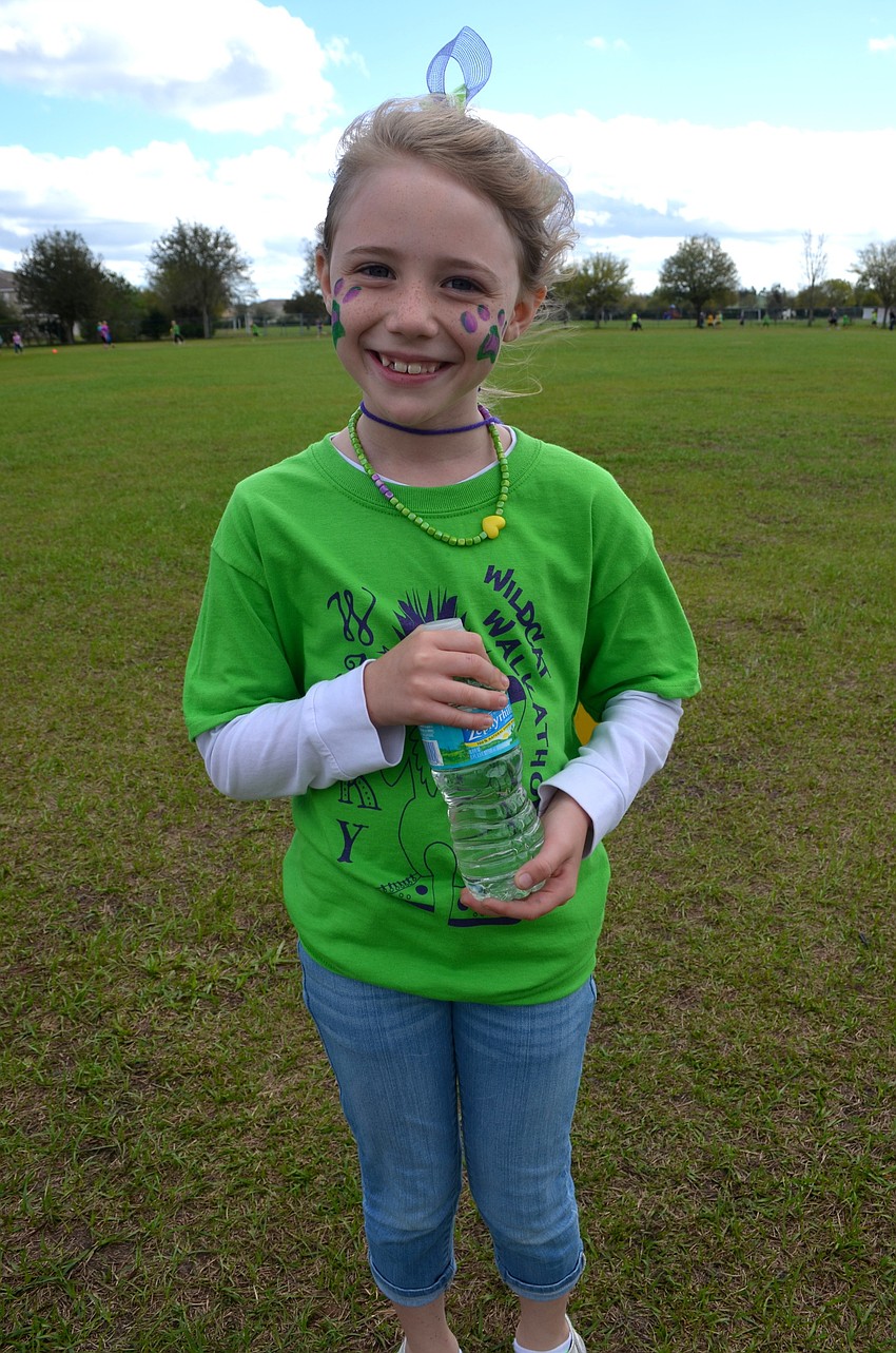 Madeline Rixon, 7, takes a break from running.