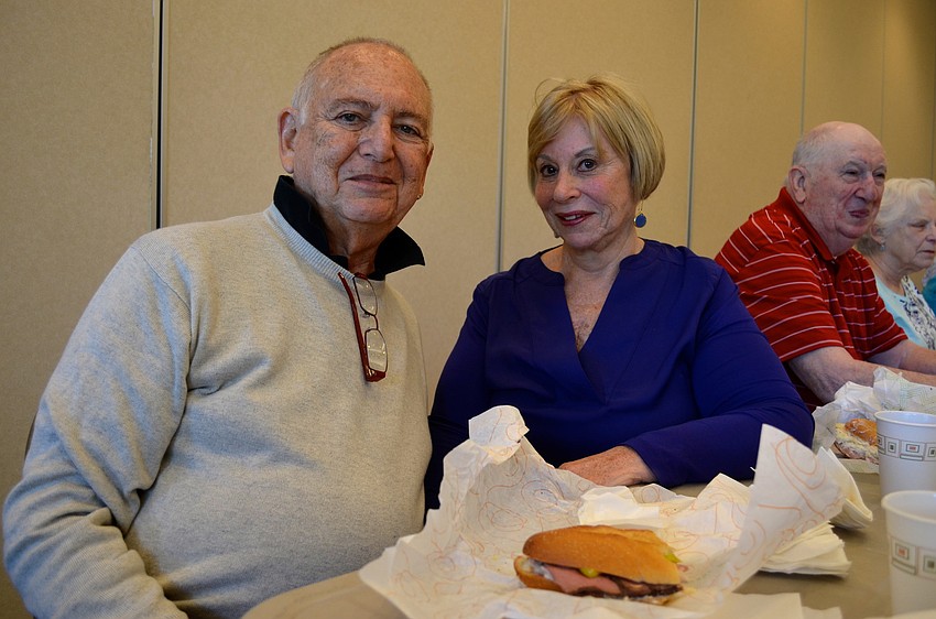 Phillip and Sandra Zemmel enjoy sandwiches while listening to the Rabbi.