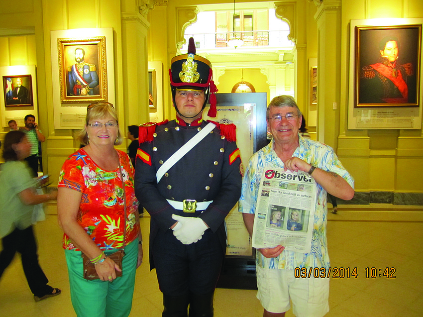 Linda and Ron Radler show their Sarasota Observer to a palace guard at the presidential palace in Buenos Aires, Argentina. The couple enjoyed a cruise from Santiago, Chile, to Buenos Aires.