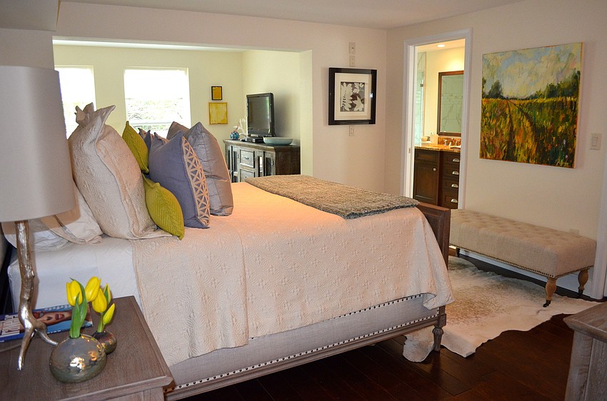 The home at 754 Spanish Dr. South features a seating area with restored family furniture in the master bedroom.