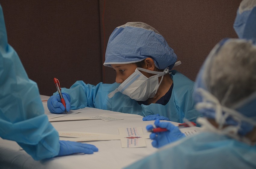 Dr. Gavin Bliele works on the operating table.