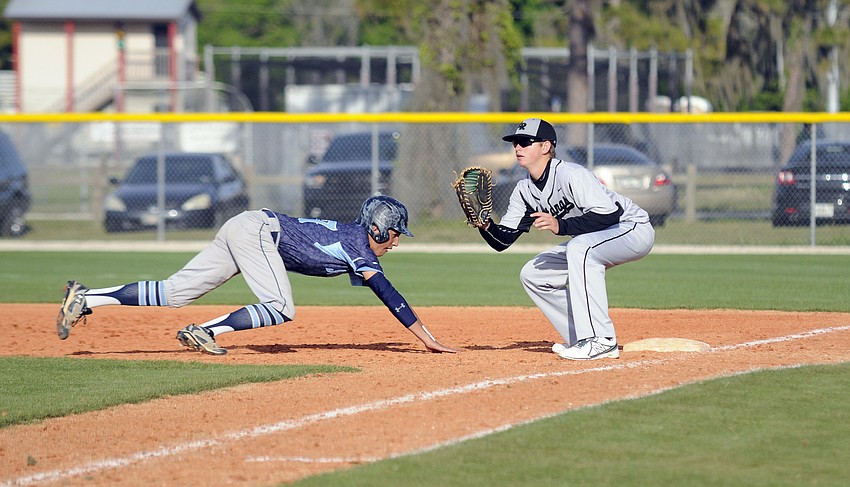 Lakewood Ranch High first baseman Colton Chupp attempts to catch a Somerset Academy base runner off the bag.