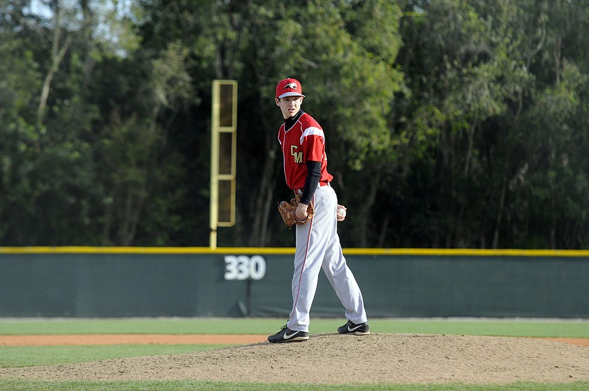 Cardinal Mooney freshman pitcher Steven Varone looks back toward first base to check on a Miami Springs base runner.