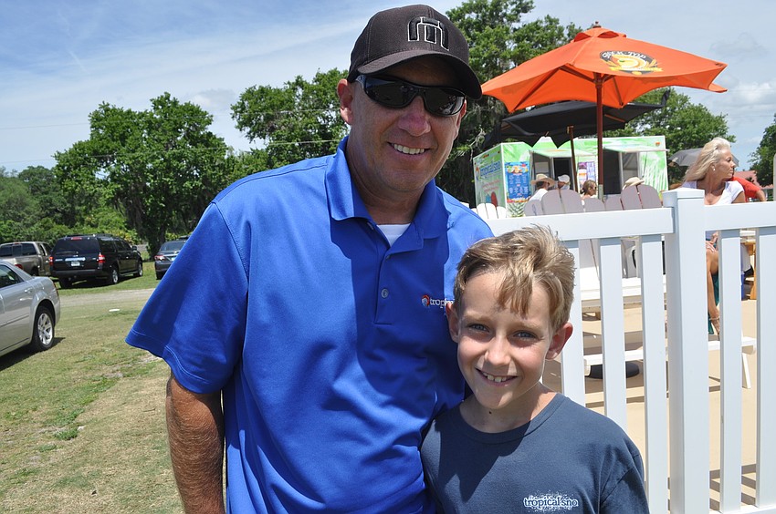 Paul Salefsky with his son Caden, 8, watched polo for the first time.