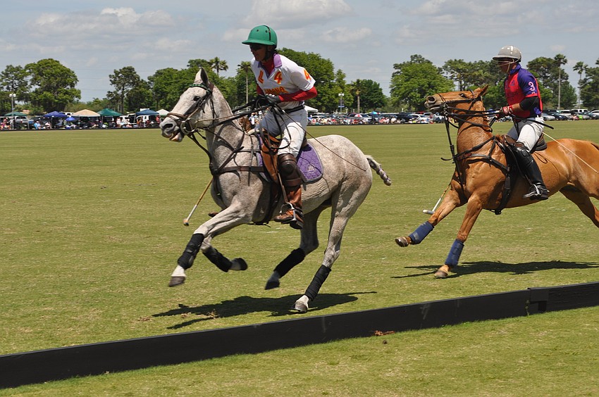 Two opponents chase the ball.