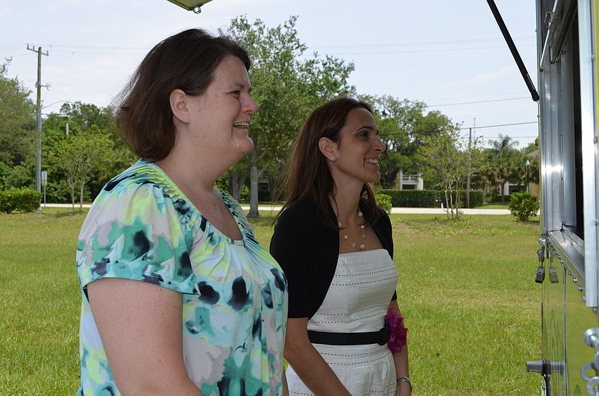 Maria Beall and Tammi Peters order tacos from Bobbos food truck.