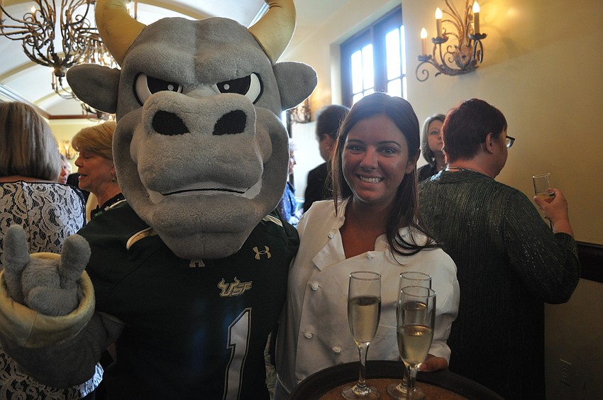 Stephanie Poxton, a USFSM hospitality management student who graduates in December, poses with the school mascot.