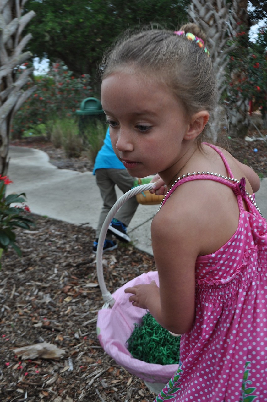 Lucy Preston rushes to find eggs hidden in the bushes.
