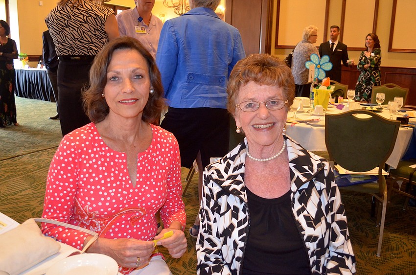 Sarah Mulroney and Sandra Schurr socialize with friends.