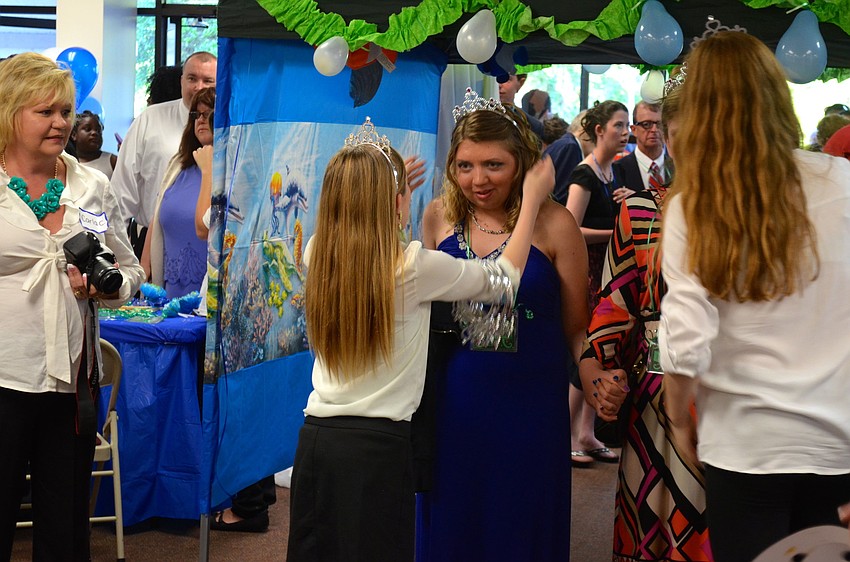 Caitlin Pfeifle receives a tiara to wear for the evening.