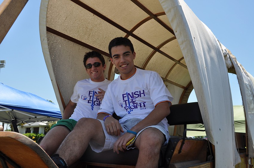 Lakewood Ranch High students Robert Collier and Francisco Suarez, of the Lakewood Leaders team, find a shady spot.