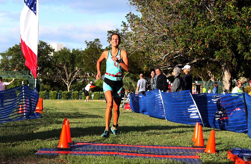 Rachel Olson Chambers crosses the finish line with a time of 1:00:55.2.