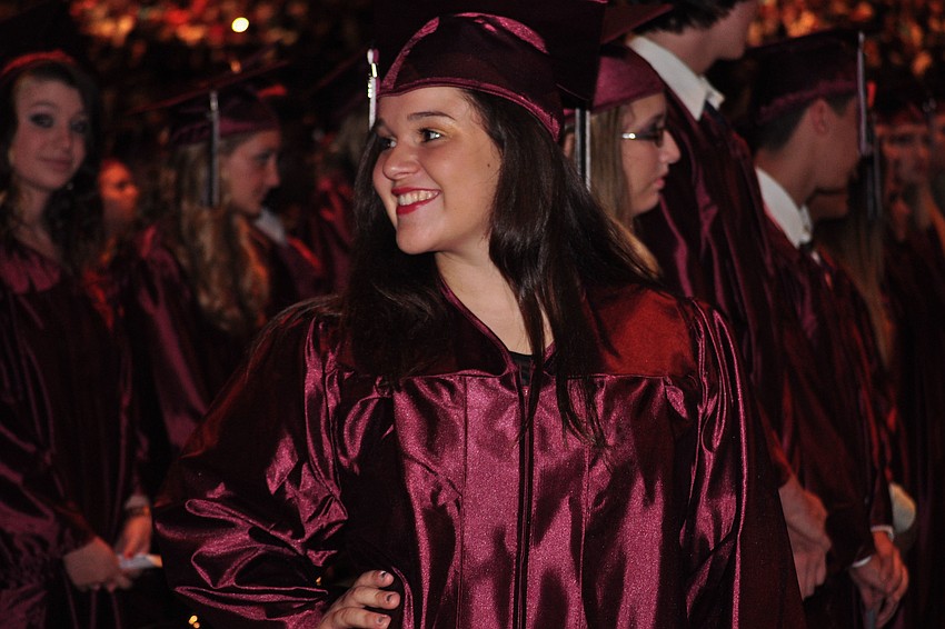 Lindsey Abner finds her family in the crowd after the ceremony begins.