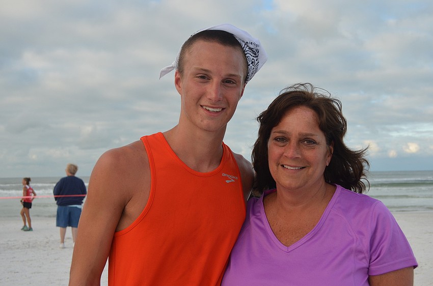Alan Burns stands with his mom Anita after finishing the 5K in second place with a time of 16:32. The family visited Sarasota from Youngstown, OH.