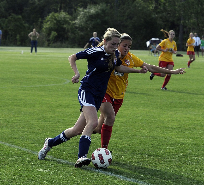 Clearwater Chargers Elite defender Paola Maymi battles a West Side Lady Eagles midfielder for possession.