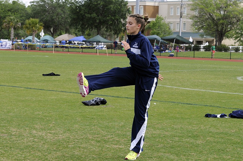 The Out-of-Door Academy eighth-grader Sophia Gardinier warms up before the start of the preliminaries of the 100-meter dash.