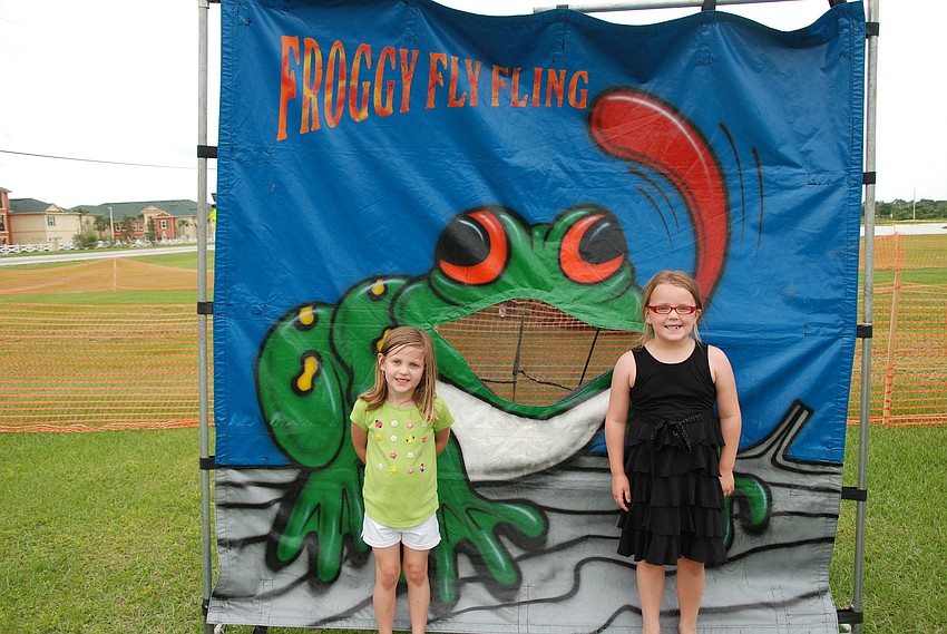 Aubrey Flint, 5, and her sister, Annesley Flint, 6, smile while playing games.