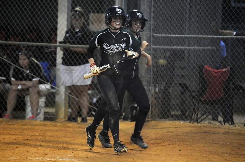 Jackie Schoff and Talli Sharp celebrate after scoring runs in the bottom of the fourth inning.