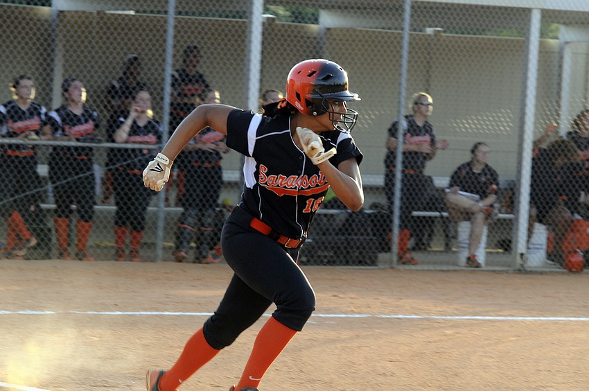 Senior Alexis Singleton races down the first base line after notching a hit in the top of the first inning.