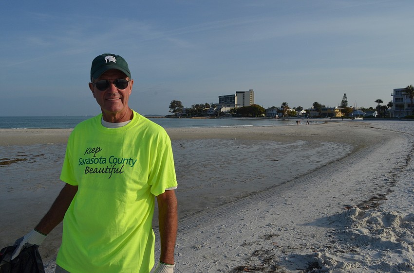 Bill Francisco picks up trash along the water.