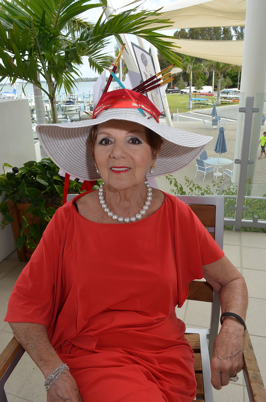 Mary Mitchell represented herself as a fashion illustrator by placing her drawings and paintbrushes in her hat.