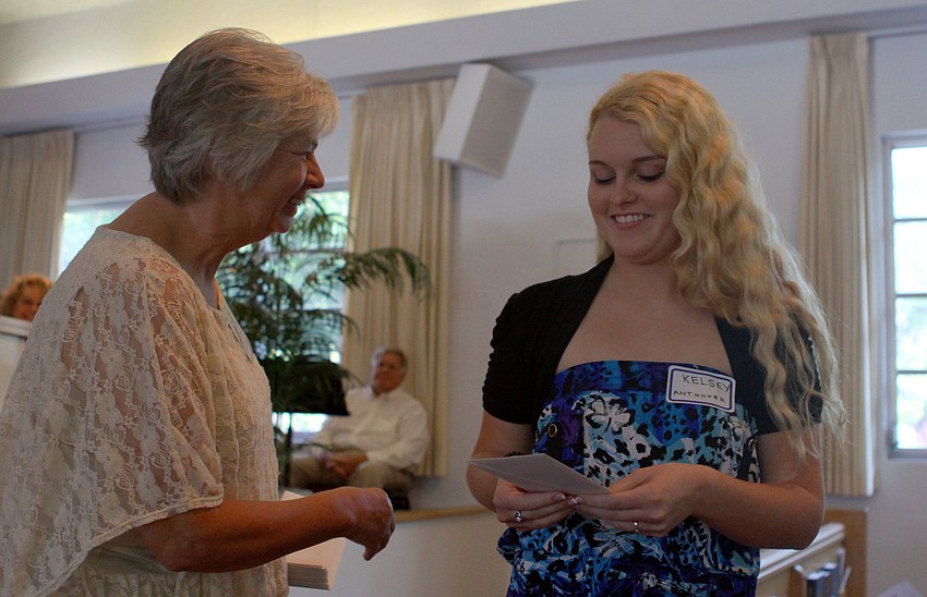Barbara Koetsier hands Kelsey Anthoefer her scholarship envelope.