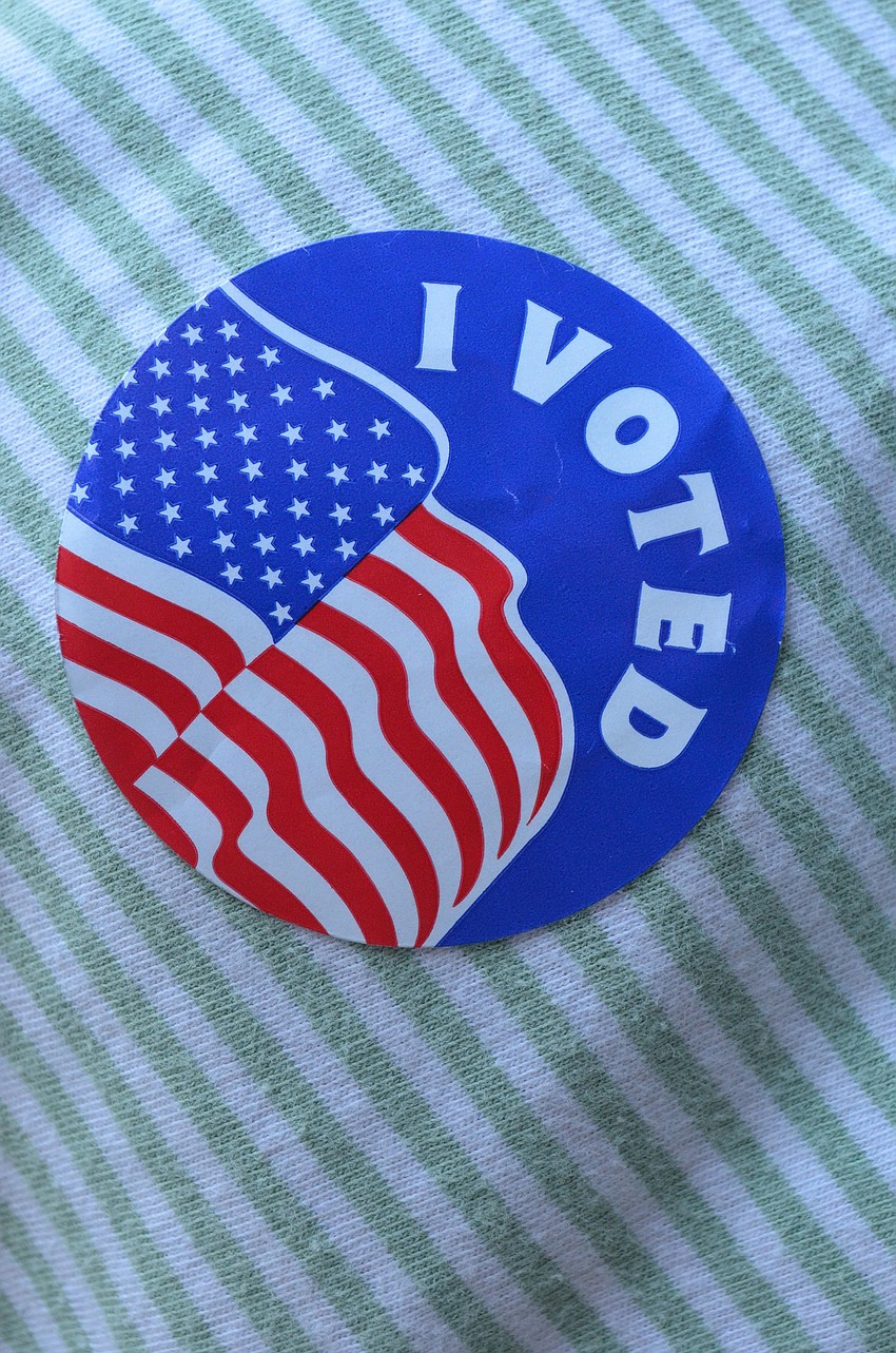 Supporters wore I voted stickers.