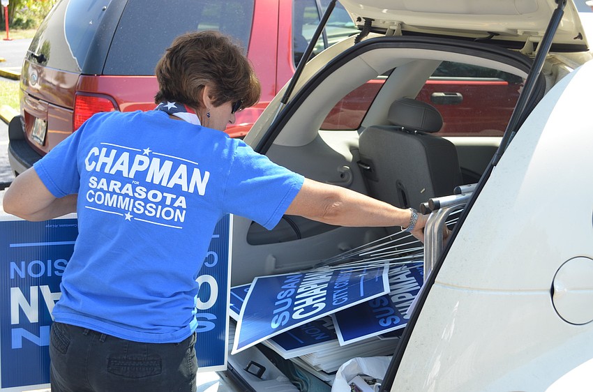Susan Chapman gets ready to put up signs at St. Paul Lutheran Church.