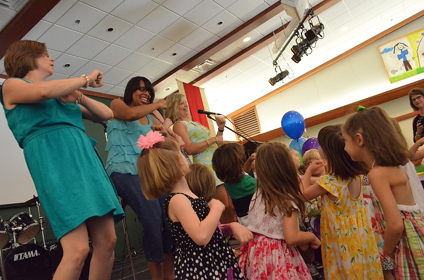 Staff dances with children at the Butterfly Ball.