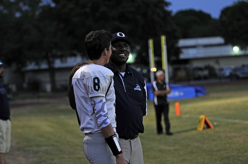 ODA head coach Brett Timmons talks with quarterback Nathan Strawderman during the second half.