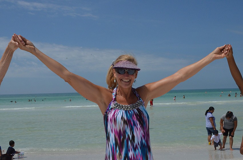 Carol Lawrence joins hands with community members to show her support of the environment.