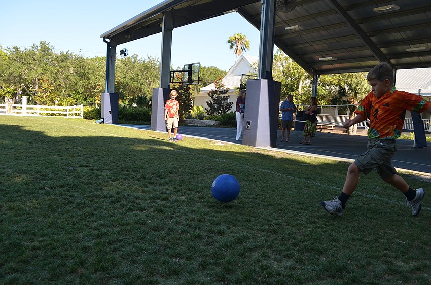 Giovani G. Gets ready to kick the ball in a game of kickball.