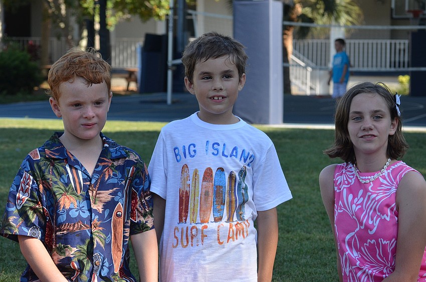 Ty G., Drew H. and Susan P. play duck duck goose during the Crossing the Mulch celebration.
