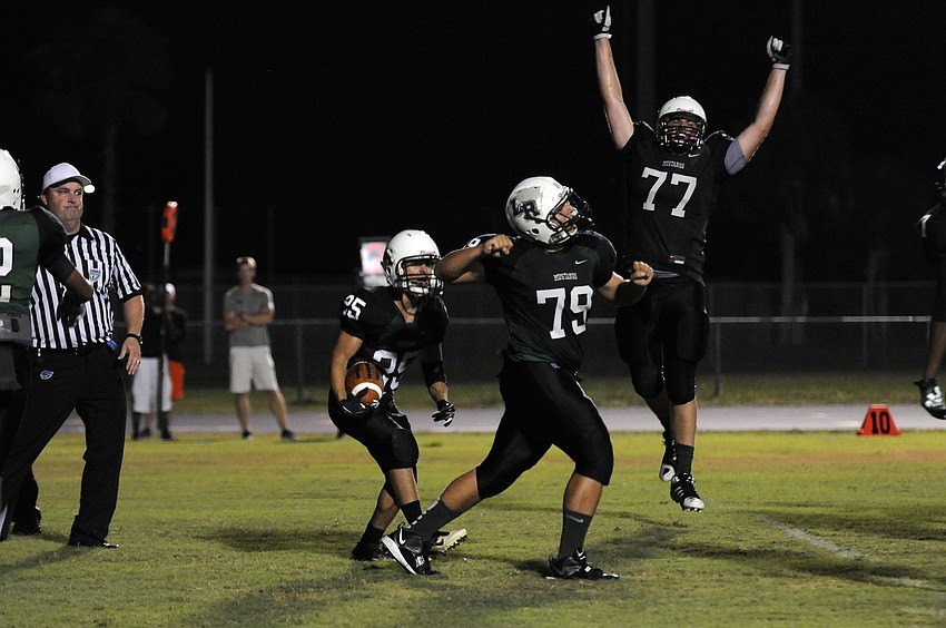 Wide receiver John Handy and offensive linemen Mark Simat and Gabriel Overmyer celebrate following Handyâ€™s 8-yard touchdown reception in the fourth quarter.