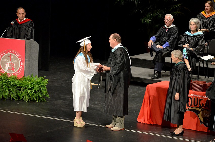 Students receive their diplomas.