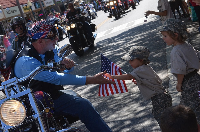 Kevin Geriowx of the Blue Knights Florida Chapter 18 shakes two-year-old Shea Bartholonewâ€™s hand.