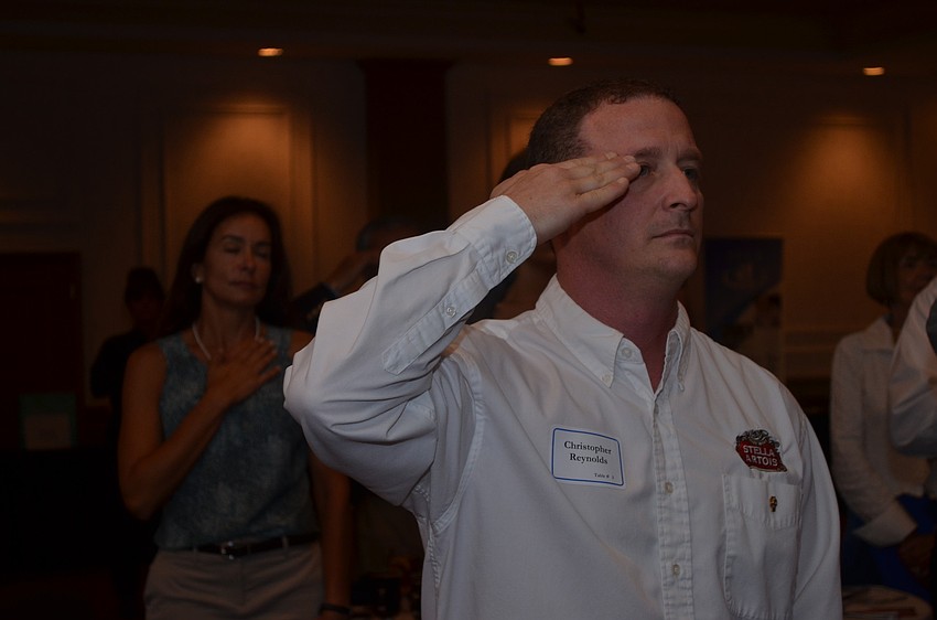 Veteran of Dessert Shield and Dessert Storm Christopher Reynolds stands for the National Anthem.