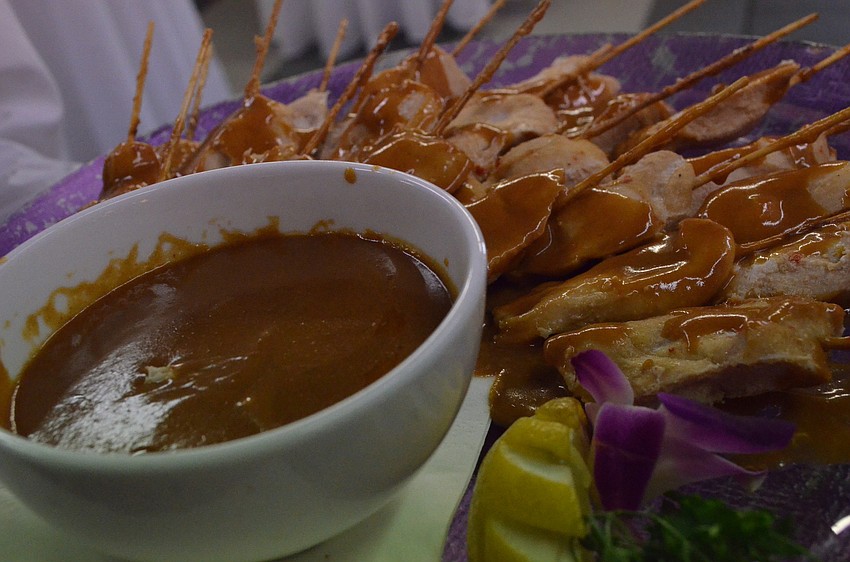 CafÃ© Lâ€™Europe catered the event where they served chicken sautÃ©ed in peanut sauce amongst other appetizers.