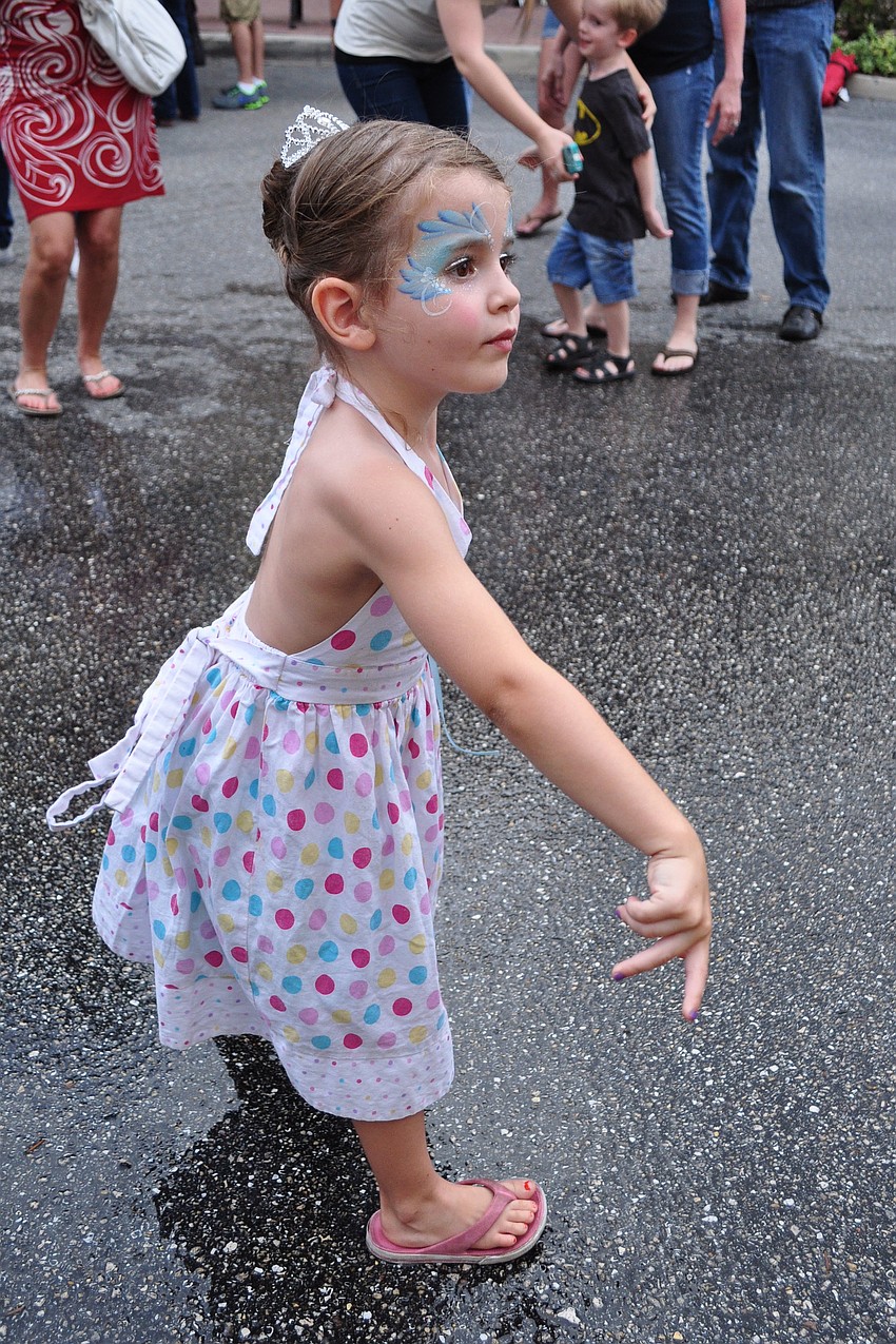Four-year-old Bella Juliano tests her aim at the dunk tank.