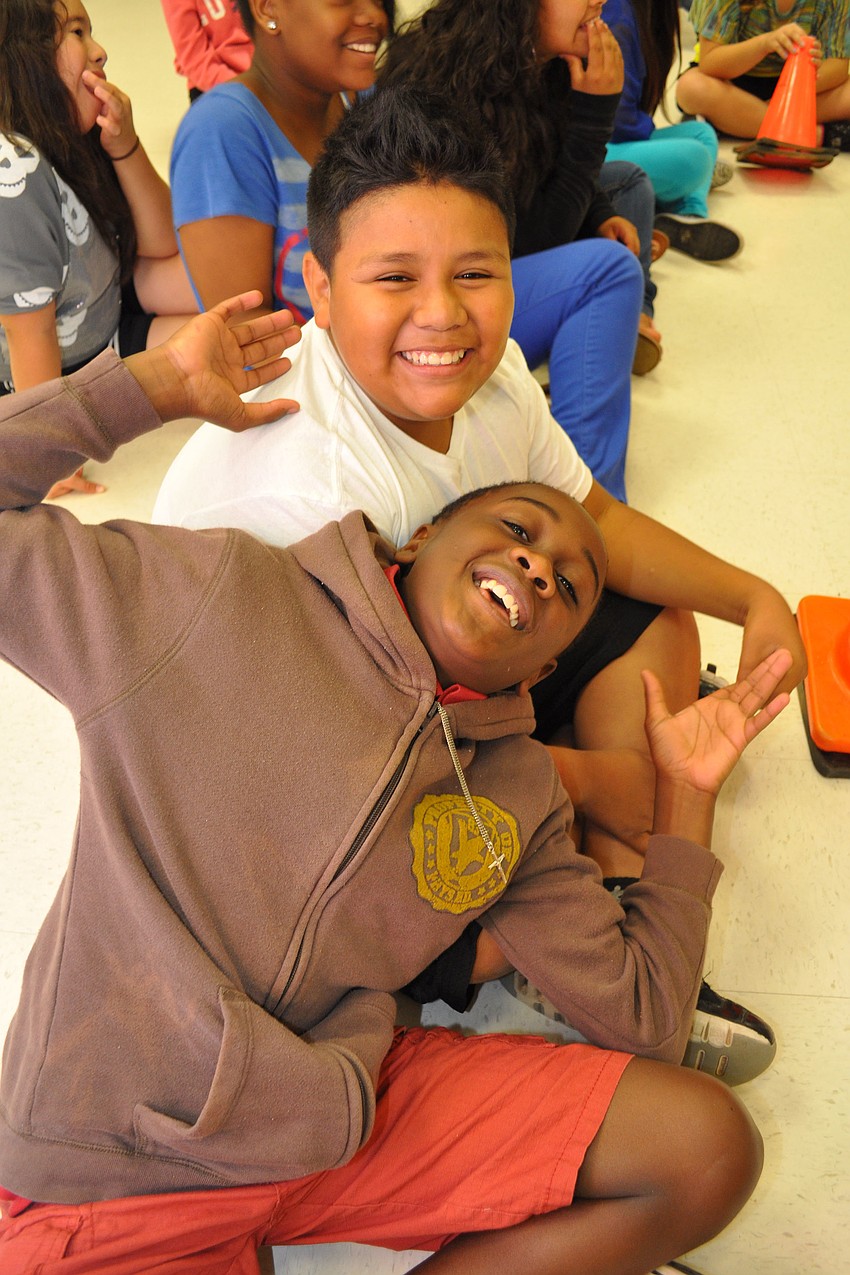 Treston Richardson, front, and Pedro Antunez, behind, eagerly watch as fellow students take on the teachers.
