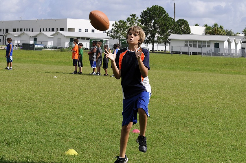 Eleven-year-old Declan Traver hauls in a pass during an agility drill.
