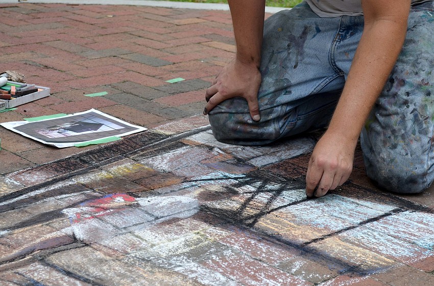 Truman Adams recreates a portrait with chalk.