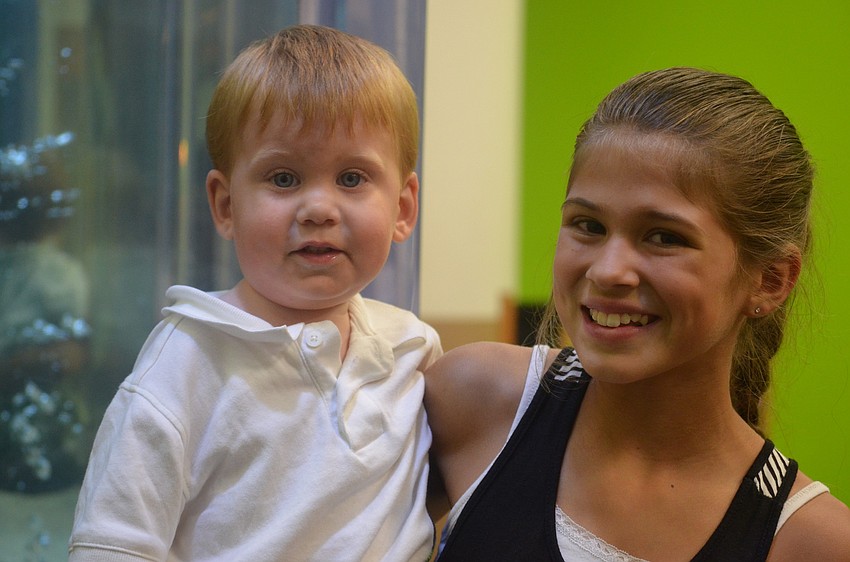 Kailey Krueger, 10, chases her 21-month-old brother Asher Wycoff around the library. Asher was ready to explore.