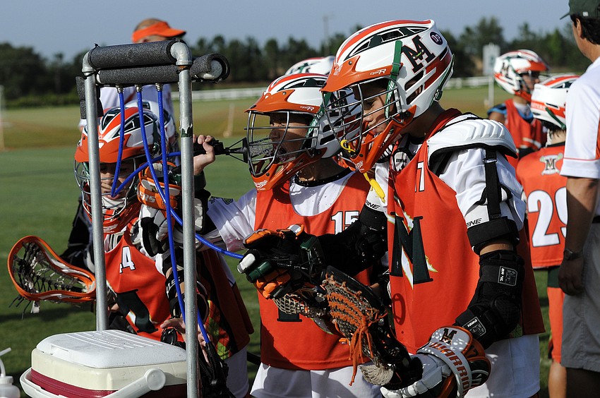 Members of the Manasota Monsters U11 Orange team cool off during their tournament opener.