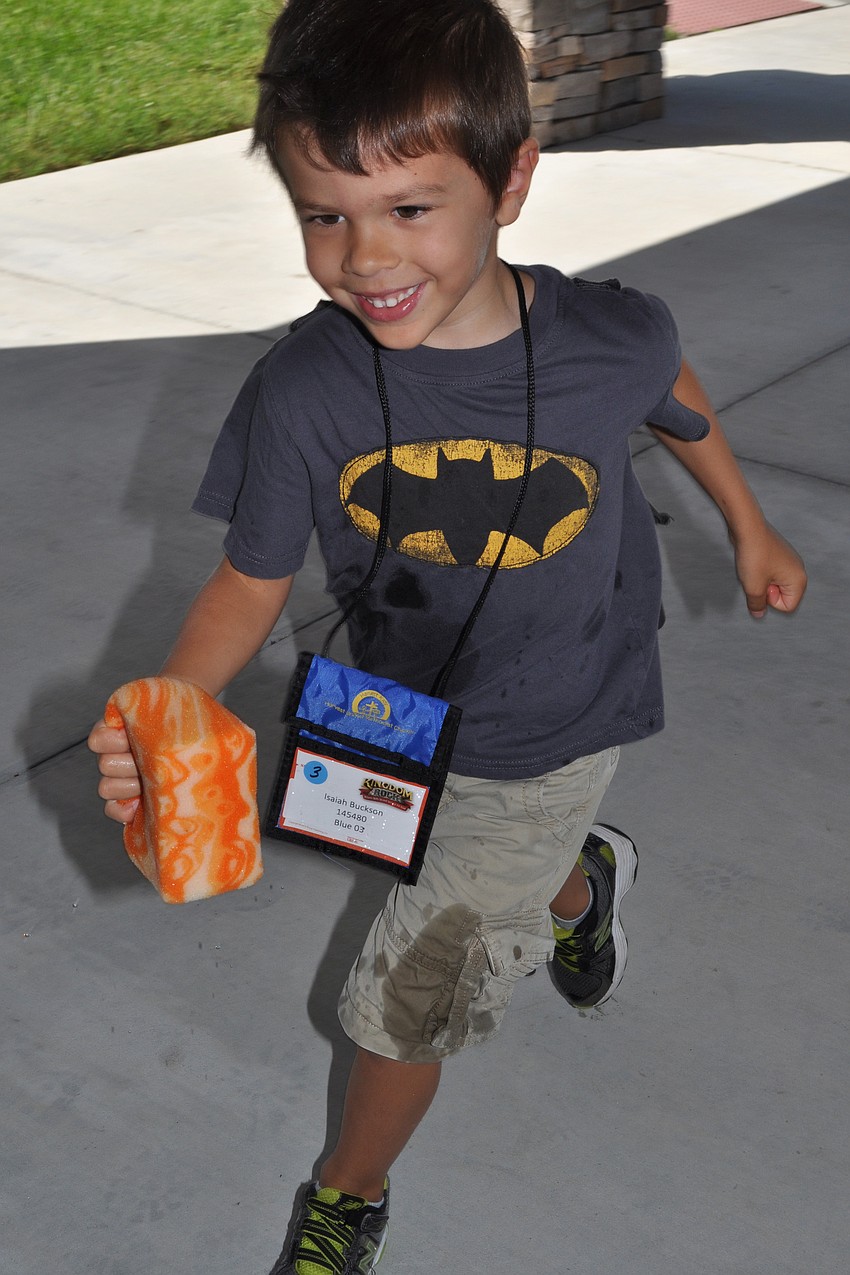 Isaiah Buckson chases a friend with a wet sponge.