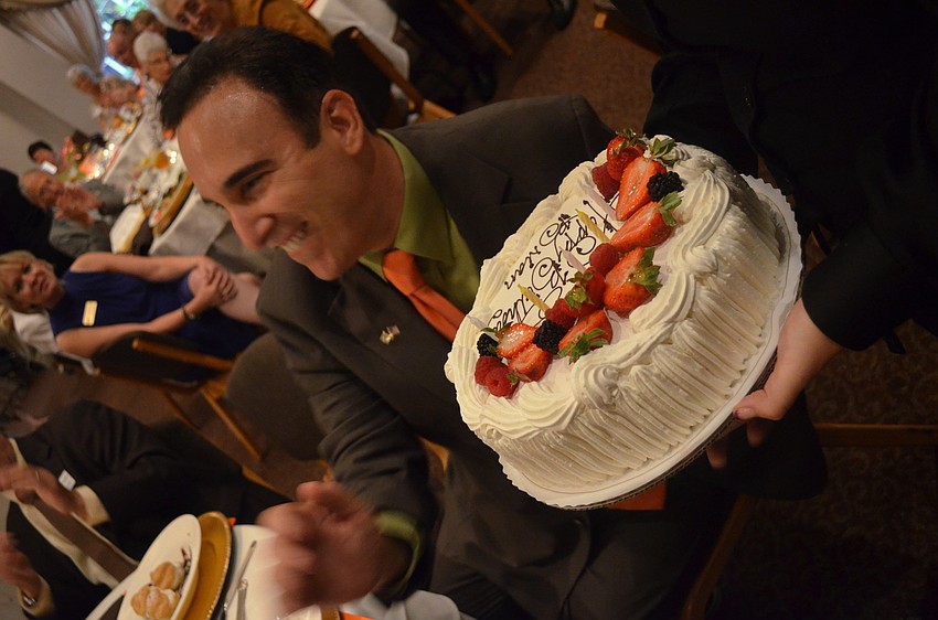 Friends surprise Brian Lipton with a cake on his birthday.